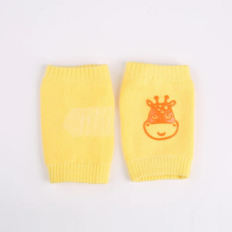 Non-slip baby knee pad in pink cotton with smiley face design, stacked with colorful pads for toddler protection during crawling.