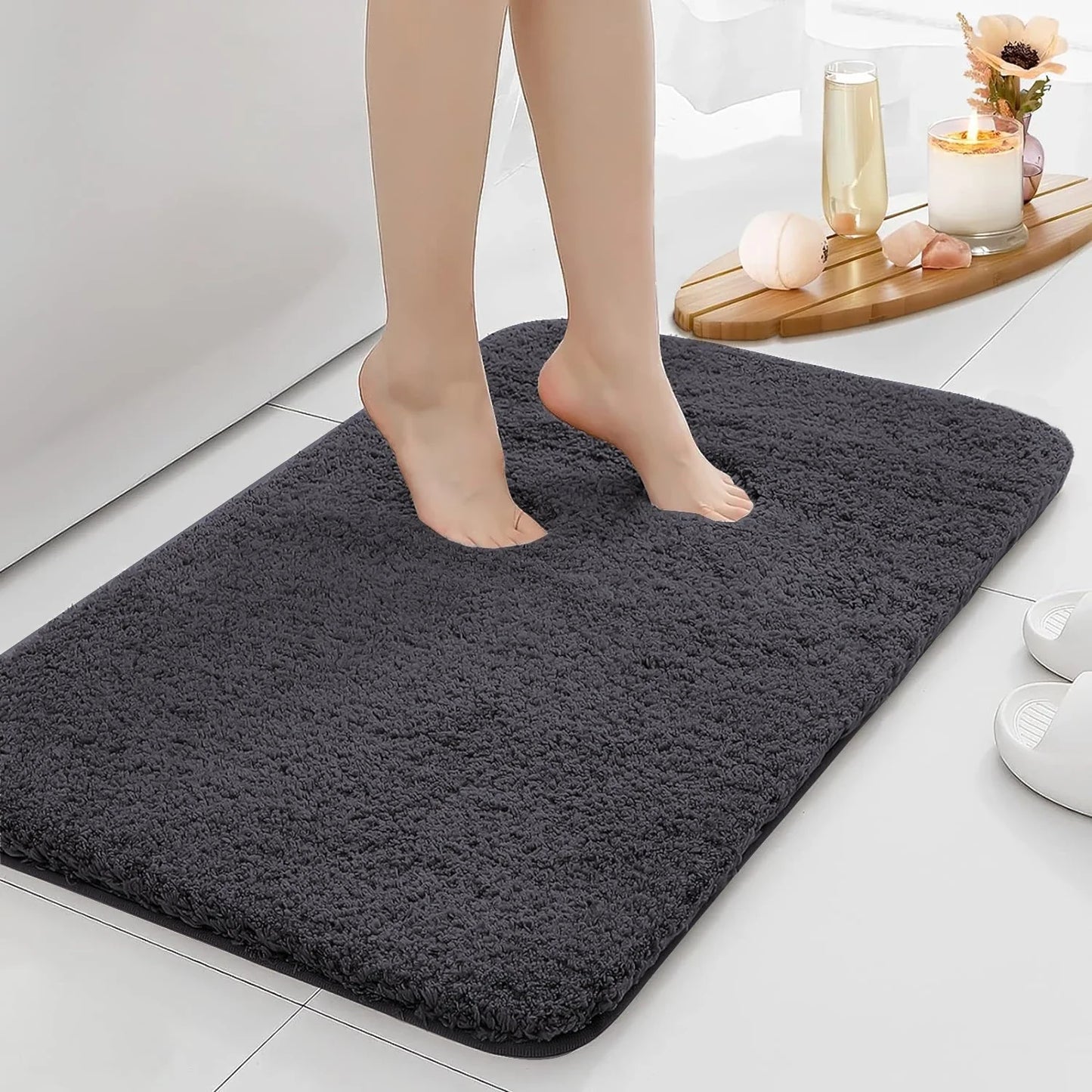 Anti-slip Bathroom Floor Mat in gray with plush texture, shown under bare feet for comfort and safety on wet bathroom floors.
