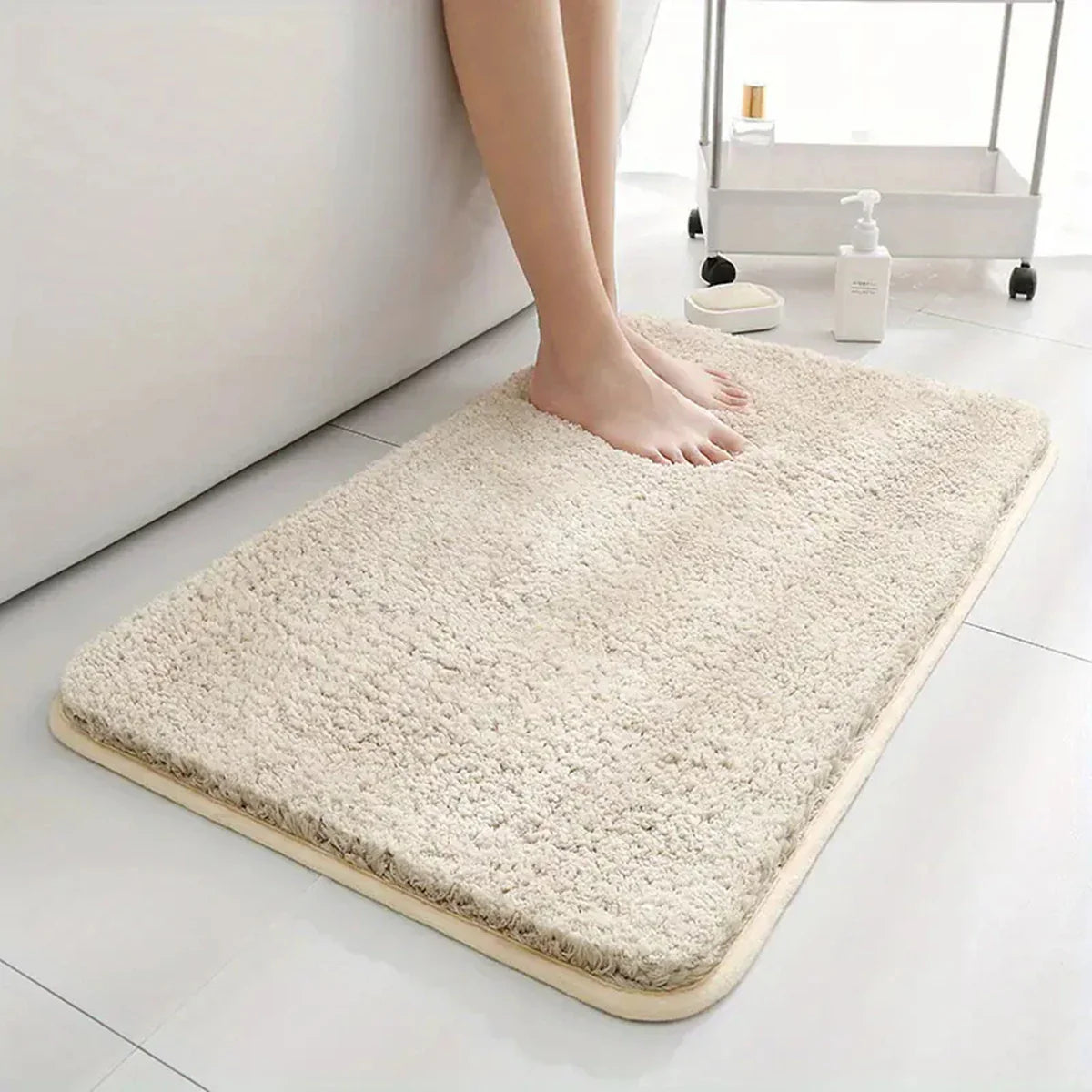 Anti-slip Bathroom Floor Mat in gray with plush texture, shown under bare feet for comfort and safety on wet bathroom floors.