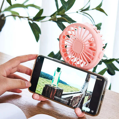 USB Rechargeable Handheld Electric Fan with flexible tripod legs and LED light, ideal for portable cooling on desks or travel use.