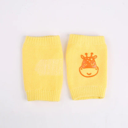 Non-slip baby knee pad in pink cotton with smiley face design, stacked with colorful pads for toddler protection during crawling.