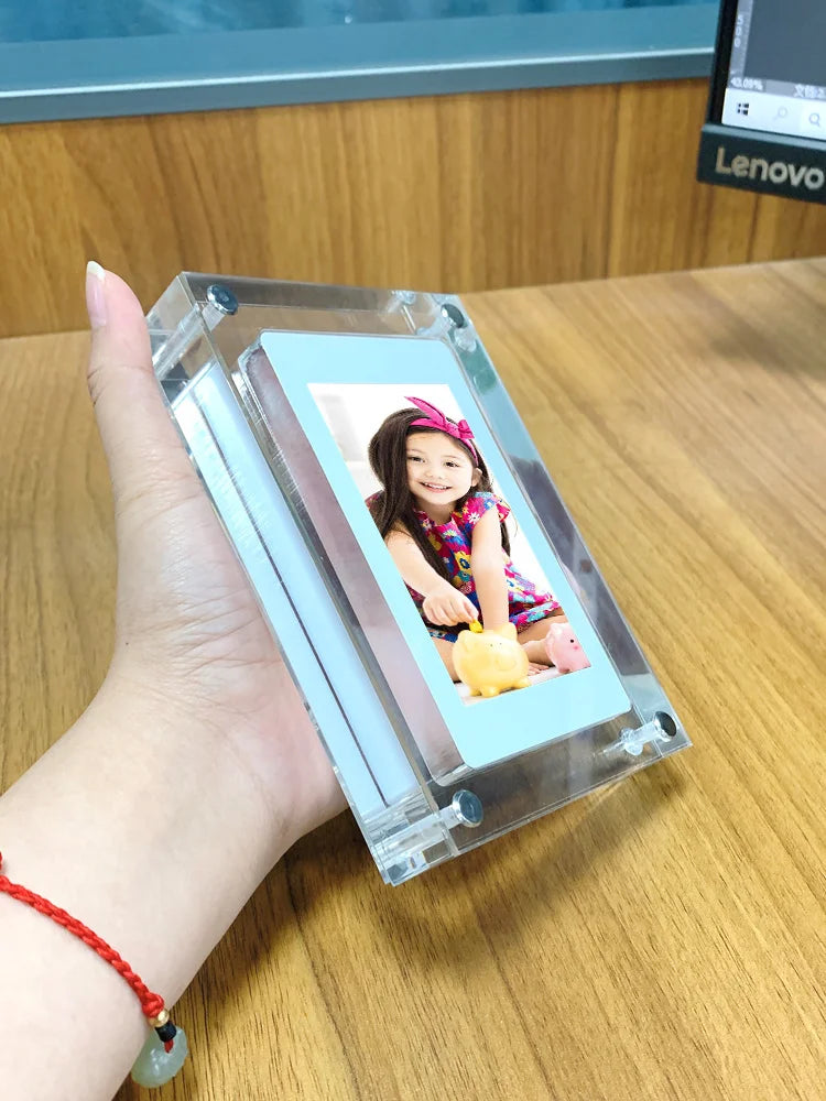 Acrylic Photo Frame - Type C Video Upload displays a winter photo of a mother and child. Clear digital frame with 480x854 IPS screen for vivid playback.