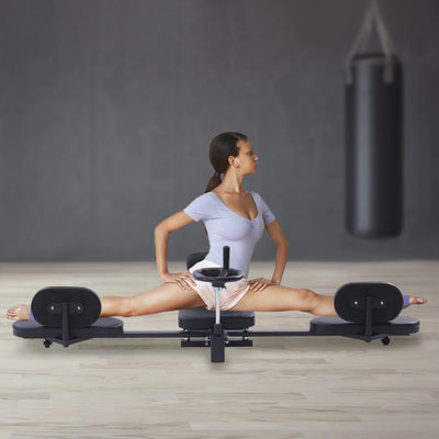 Heavy Duty Leg Stretcher Machine used by woman in full split position in gym setting. Ideal for improving flexibility and joint mobility.