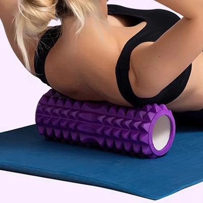 Fitness Pilates Foam Roller in purple used for back massage during workout. EVA material roller ideal for yoga and muscle recovery exercises.